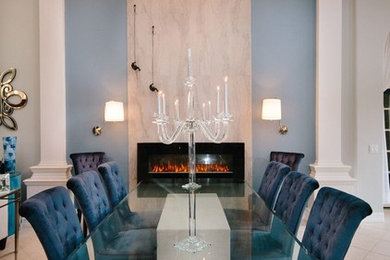 Enclosed dining room - large transitional travertine floor and beige floor enclosed dining room idea in Miami with white walls, a ribbon fireplace and a stone fireplace
