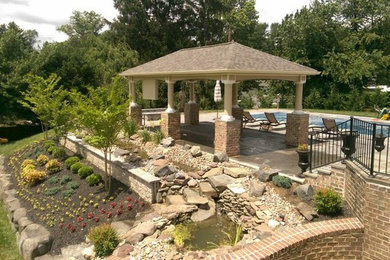 Design ideas for a huge transitional full sun backyard stone formal garden in Baltimore for summer.
