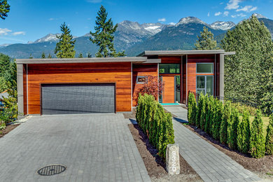 Example of a large minimalist brown two-story wood exterior home design in Other