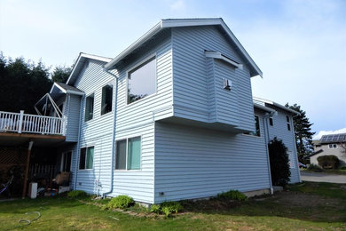 Traditional blue two-story vinyl house exterior idea in Seattle