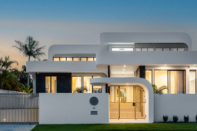 This is an example of a large modern two-storey white house exterior in Gold Coast - Tweed with a flat roof.