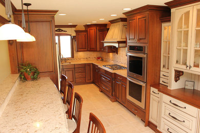 Eat-in kitchen - mid-sized traditional u-shaped porcelain tile eat-in kitchen idea in Other with an undermount sink, raised-panel cabinets, medium tone wood cabinets, quartz countertops, beige backsplash, porcelain backsplash and stainless steel appliances