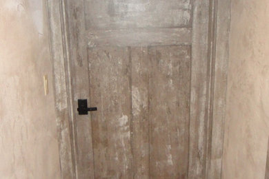 Large elegant medium tone wood floor and beige floor wine cellar photo in Portland Maine