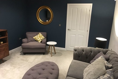 Photo of a medium sized retro enclosed living room in Other with blue walls, carpet, a wall mounted tv and grey floors.