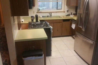 Inspiration for a contemporary porcelain tile and brown floor kitchen remodel in Orlando with a farmhouse sink, granite countertops, multicolored backsplash, porcelain backsplash, stainless steel appliances and multicolored countertops