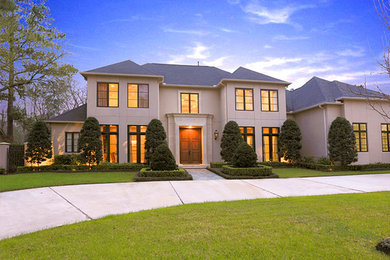 Example of a large trendy concrete floor entryway design in Houston with beige walls and a medium wood front door