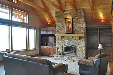 Inspiration for a large country open concept living room in Seattle with beige walls, carpet, a standard fireplace, a stone fireplace surround and a built-in media wall.