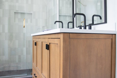 Mid-sized minimalist master gray tile and subway tile porcelain tile, black floor and double-sink bathroom photo in Dallas with shaker cabinets, light wood cabinets, white walls, an undermount sink, quartz countertops, a hinged shower door, white countertops, a niche and a freestanding vanity