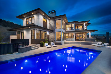Huge contemporary white two-story mixed siding house exterior idea in Other with a hip roof and a shingle roof