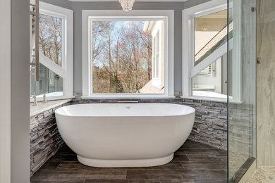 Bathroom - large transitional master gray tile and porcelain tile porcelain tile and black floor bathroom idea in Other with furniture-like cabinets, gray cabinets, a two-piece toilet, gray walls, an undermount sink, quartz countertops and a hinged shower door