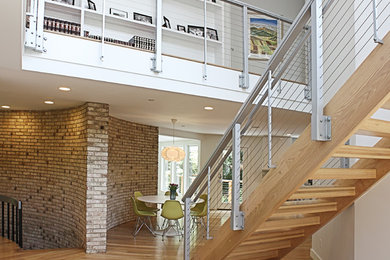 Photo of a mid-sized contemporary wood straight staircase in DC Metro with open risers.