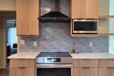 Example of a mid-sized 1950s u-shaped vinyl floor enclosed kitchen design in Seattle with flat-panel cabinets, blue backsplash, subway tile backsplash, no island and white countertops