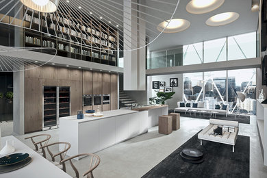 Example of a minimalist single-wall concrete floor and gray floor kitchen design in San Francisco with flat-panel cabinets, white cabinets, no island and quartzite countertops