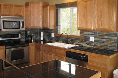 Open concept kitchen - large rustic l-shaped open concept kitchen idea in Other with a double-bowl sink, raised-panel cabinets, medium tone wood cabinets, granite countertops, multicolored backsplash, matchstick tile backsplash, stainless steel appliances and an island