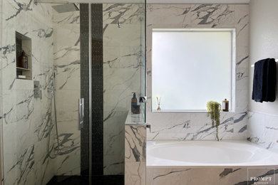 Bathroom - mid-sized modern master multicolored tile and porcelain tile vinyl floor, brown floor, double-sink and tray ceiling bathroom idea in Austin with flat-panel cabinets, blue cabinets, gray walls, an undermount sink, marble countertops, a hinged shower door, a niche and a floating vanity