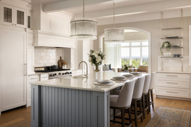 Example of a huge transitional brown floor, shiplap ceiling, exposed beam and medium tone wood floor kitchen design in Calgary with a farmhouse sink, shaker cabinets, white cabinets, quartz countertops, white backsplash, porcelain backsplash, paneled appliances, an island and white countertops