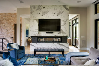Inspiration for a contemporary light wood floor family room remodel in Denver with beige walls, a two-sided fireplace and a media wall