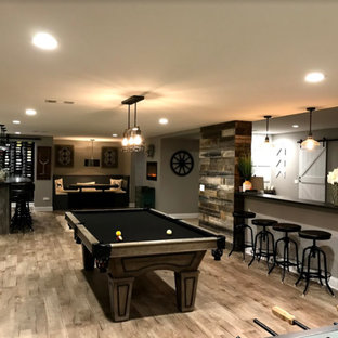 Design ideas for a large traditional fully buried basement in Other with beige walls, light hardwood flooring, no fireplace and beige floors.