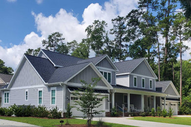 Mid-sized traditional gray two-story concrete fiberboard and board and batten exterior home idea in Charleston with a mixed material roof and a black roof