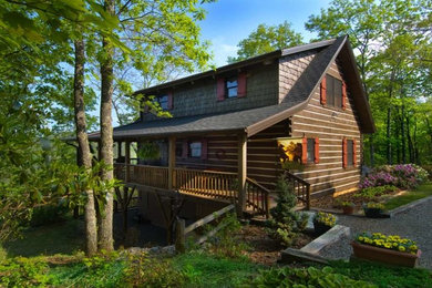 Example of a mid-sized mountain style brown two-story wood gable roof design in Nashville