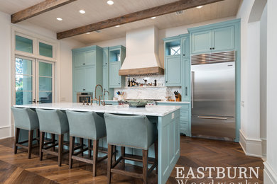 Inspiration for a beach style eat-in kitchen in Miami with a farmhouse sink, shaker cabinets, blue cabinets, marble splashback, stainless steel appliances and with island.