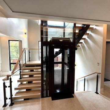 Project #136 | Modern Floating Staircase Encircling Glass Elevator