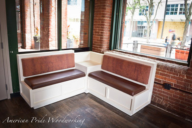 This is an example of a medium sized industrial l-shaped breakfast bar in Boston with dark hardwood flooring and brown floors.