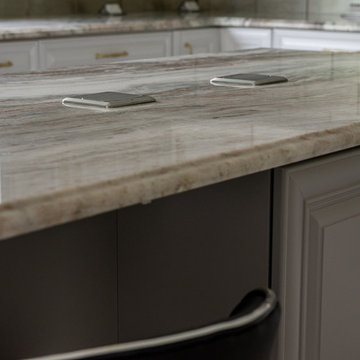 Transitional Kitchen Done in a 2 Tone Color With Integrated Dining Table