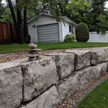 Natural boulder retaining wall in Edmonton