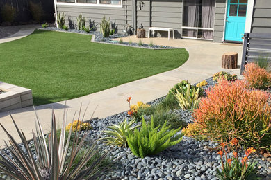 Design ideas for a large contemporary front yard full sun xeriscape in San Diego with gravel.