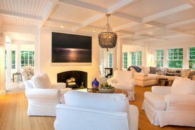 Living room - large coastal light wood floor, beige floor and wood ceiling living room idea in Portland Maine with white walls, a standard fireplace and a brick fireplace