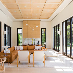 Example of a large trendy formal and enclosed light wood floor and beige floor living room design in Miami with beige walls, no fireplace and no tv