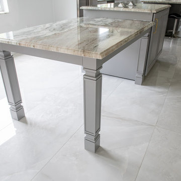 Transitional Kitchen Done in a 2 Tone Color With Integrated Dining Table