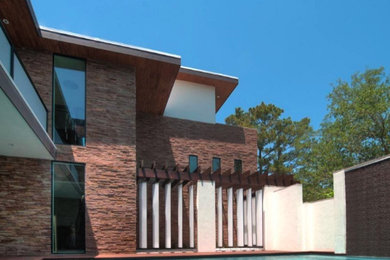 Large minimalist rectangular pool photo in Houston with decking