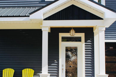 Entryway - large entryway idea in Other with black walls and a white front door