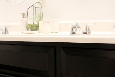 Bathroom - mid-sized eclectic bathroom idea in New Orleans with black cabinets and white walls