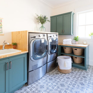 This is an example of a medium sized classic l-shaped separated utility room in Nashville with a built-in sink, shaker cabinets, green cabinets, wood worktops, white walls, ceramic flooring, a side by side washer and dryer, multi-coloured floors and brown worktops.