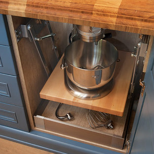 Design ideas for a large traditional l-shaped kitchen pantry in Phoenix with a farmhouse sink, raised-panel cabinets, white cabinets, wood benchtops, multi-coloured splashback, coloured appliances, medium hardwood floors, multiple islands, brown floor and brown benchtop.