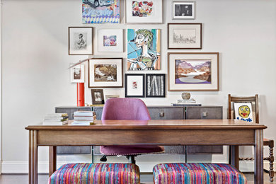 Example of a freestanding desk dark wood floor and brown floor home office design in Houston with gray walls
