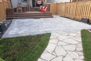 Inspiration for a large timeless backyard concrete paver patio remodel in Toronto with no cover