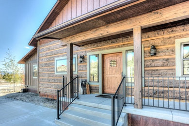 Small arts and crafts concrete front porch photo in Other with a roof extension
