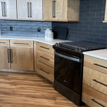 Angled Kitchen Design with Slab Style Cabinets in Pecan Stain