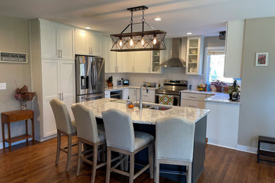 Example of a mid-sized minimalist u-shaped eat-in kitchen design in Other with white cabinets, quartz countertops, white backsplash, subway tile backsplash and an island