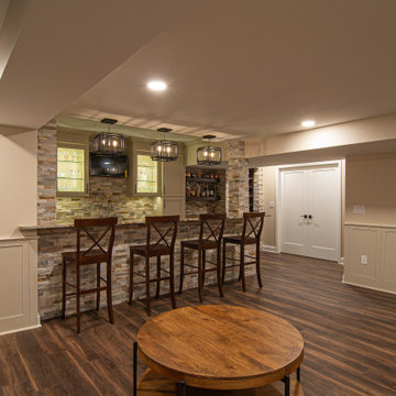 Basement Showing Warm Colors, Straight Lined Cabinets and Stacked Stone