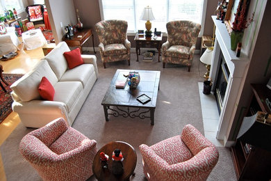 Example of a mid-sized trendy open concept carpeted living room design in Cleveland with gray walls, a standard fireplace and a tile fireplace