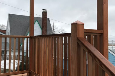 Photo of a small traditional deck in Boston with a roof extension.