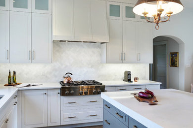 Inspiration for a large timeless u-shaped medium tone wood floor eat-in kitchen remodel in Toronto with a double-bowl sink, raised-panel cabinets, white cabinets, soapstone countertops, white backsplash, mosaic tile backsplash, white appliances and an island