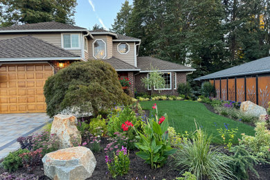 Inspiration for a mid-sized eclectic rock and full sun front yard concrete paver and metal fence landscaping in Seattle for summer.