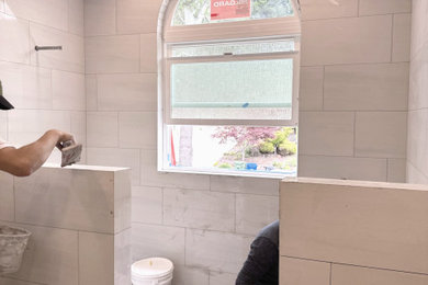 Bathroom - mid-sized transitional master gray tile and porcelain tile porcelain tile, gray floor and double-sink bathroom idea in Other with shaker cabinets, white cabinets, a one-piece toilet, an undermount sink, quartz countertops, white countertops and a built-in vanity