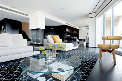 Example of a mid-sized trendy open concept porcelain tile and black floor family room design in New York with white walls, no fireplace and no tv